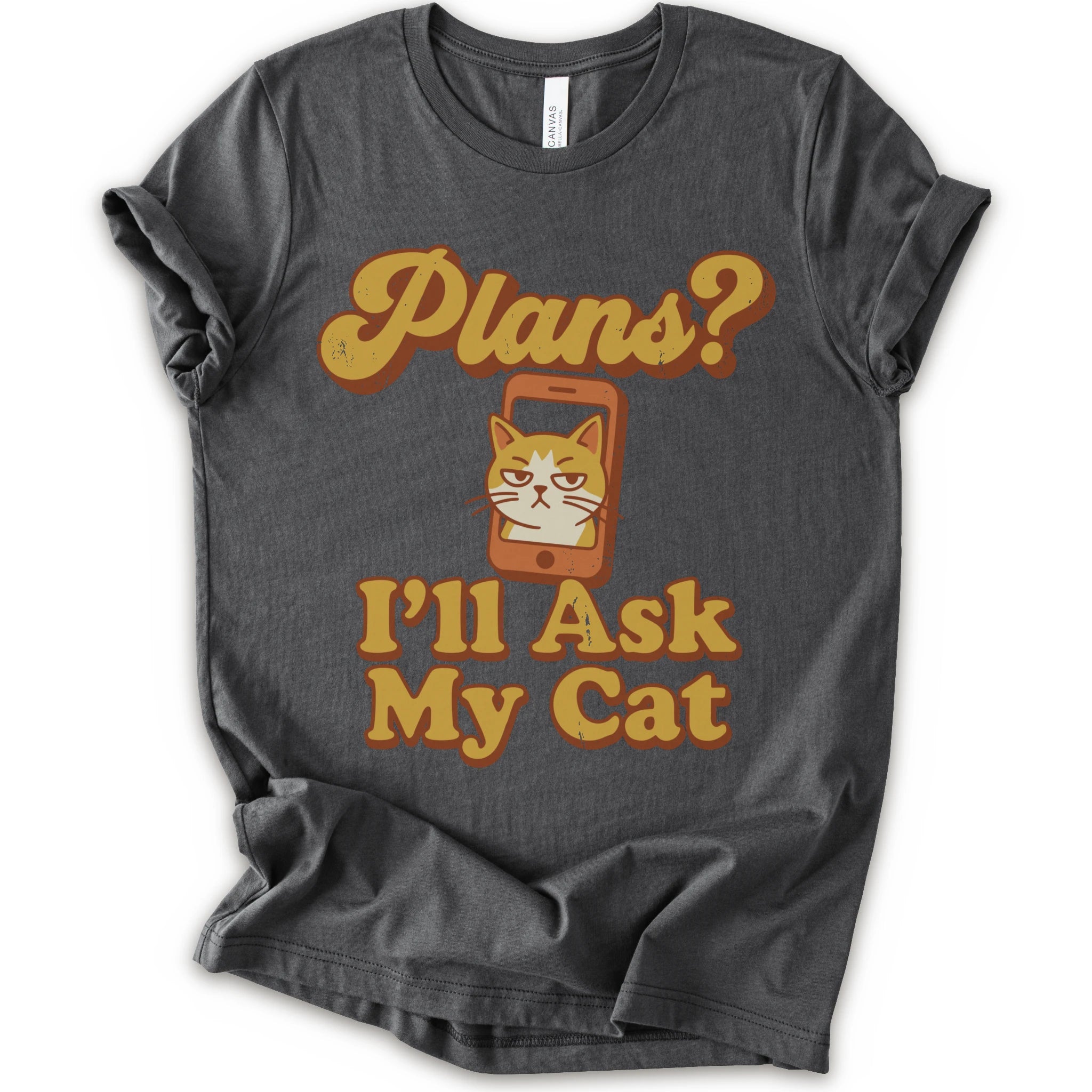 A asphalt crewneck t-shirt with a graphic print that reads 'Plans? I'll Ask My Cat' in a retro yellow-orange font, featuring a grumpy orange tabby cat cartoon inside a smartphone.