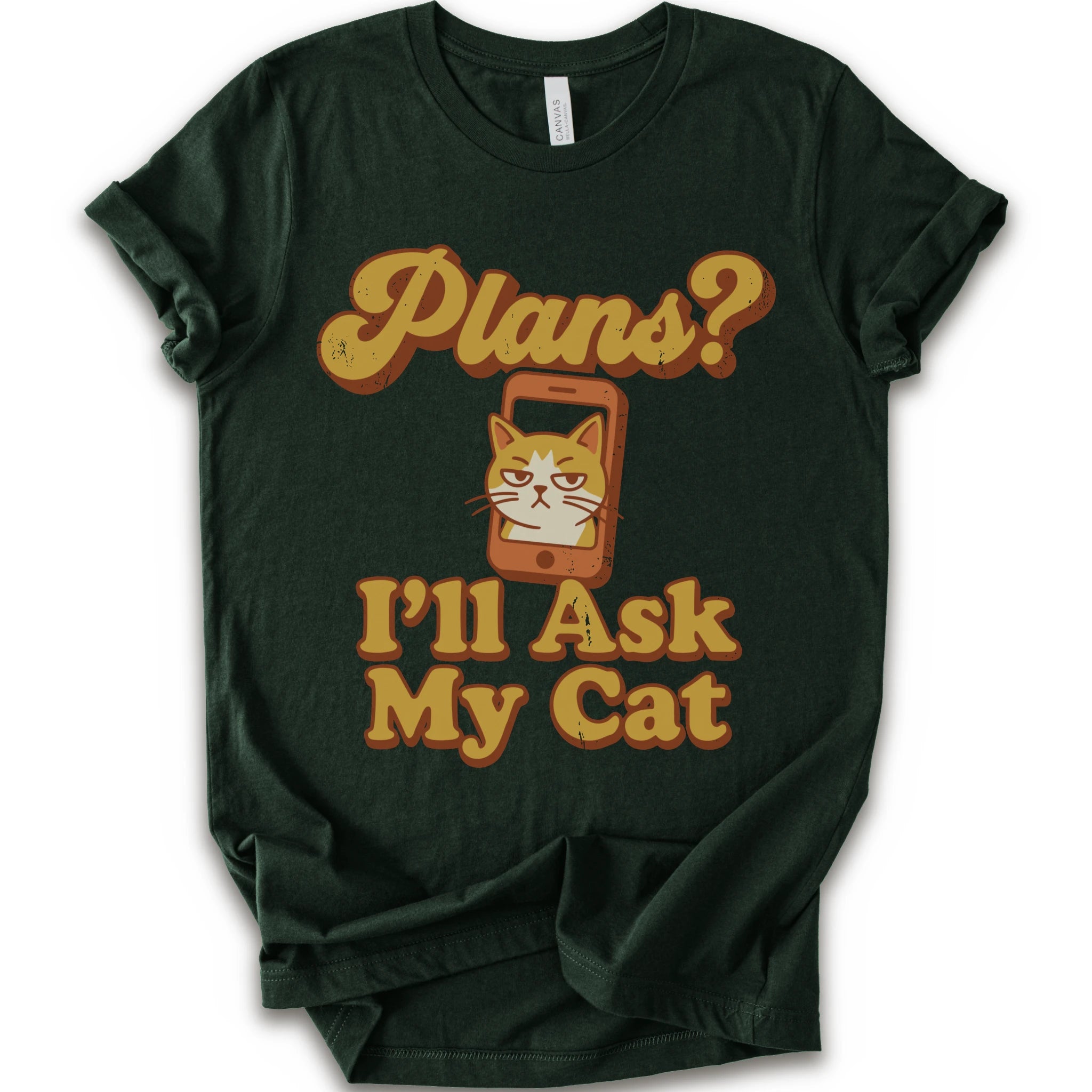 A forest crewneck t-shirt with a graphic print that reads 'Plans? I'll Ask My Cat' in a retro yellow-orange font, featuring a grumpy orange tabby cat cartoon inside a smartphone.