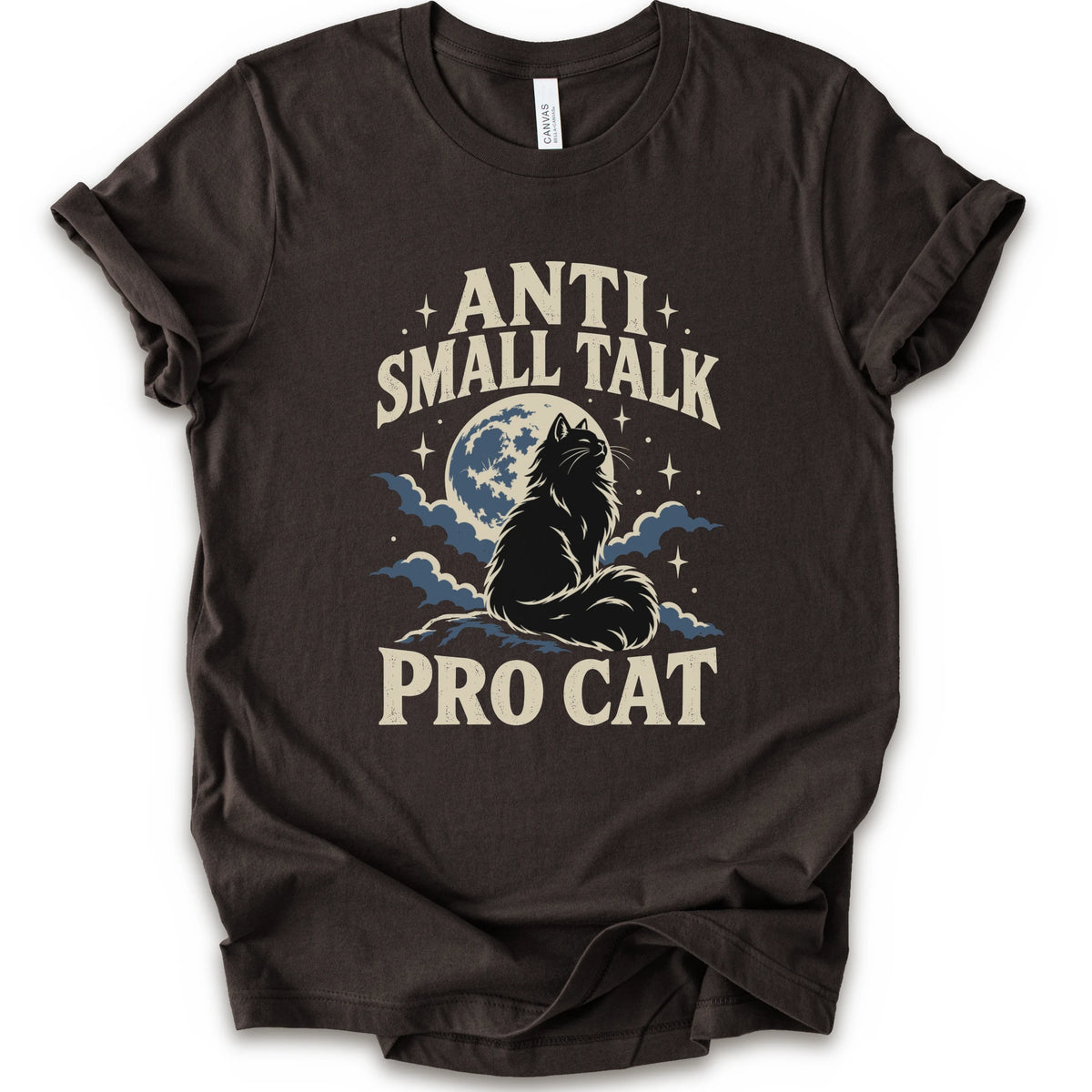 A brown short-sleeve t-shirt with a graphic print featuring a cat silhouette in front of a full moon and clouds, with the text 'ANTI SMALL TALK PRO CAT' in a cream-colored font.