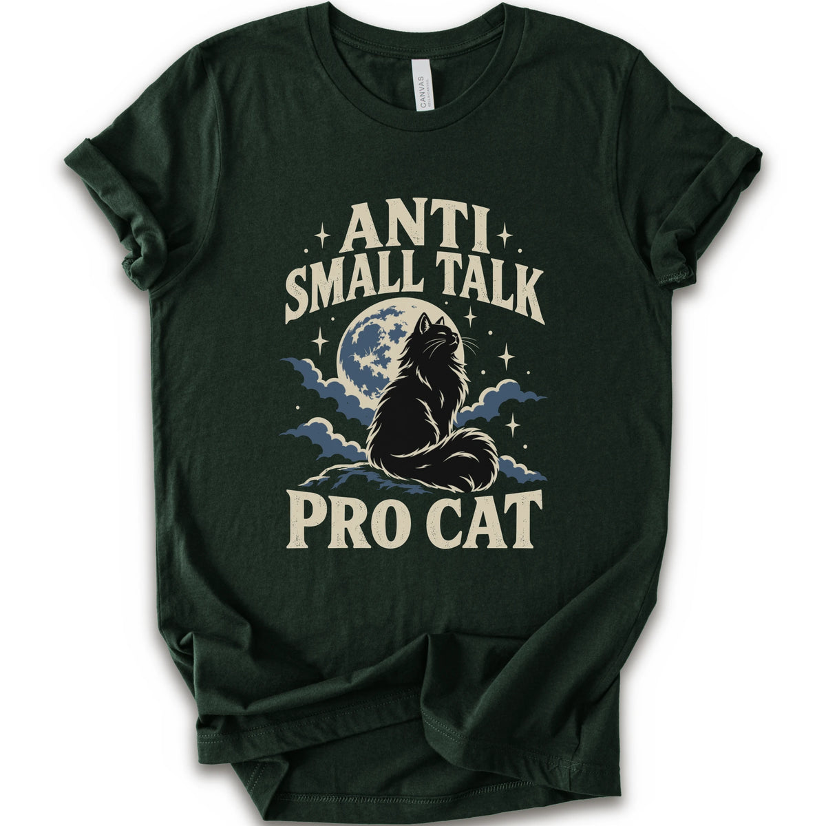 A forest short-sleeve t-shirt with a graphic print featuring a cat silhouette in front of a full moon and clouds, with the text 'ANTI SMALL TALK PRO CAT' in a cream-colored font.
