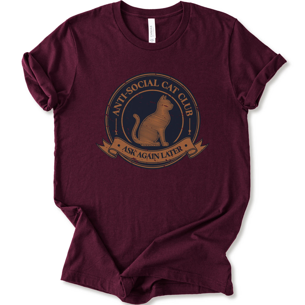 A maroon crewneck t-shirt with a distressed graphic of a cat inside a circular seal that reads 'ANTI-SOCIAL CAT CLUB' and 'ASK AGAIN LATER'.