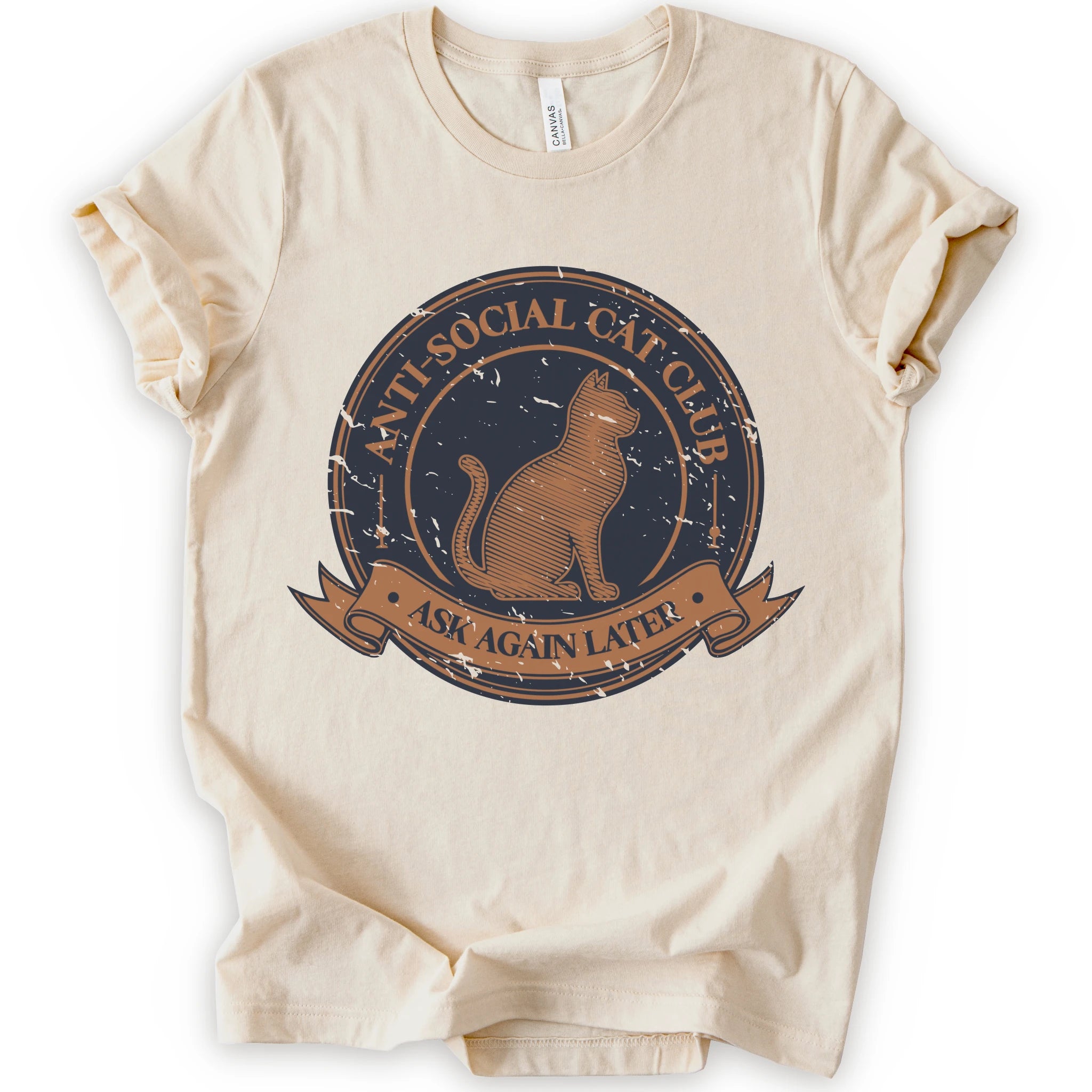 A natural short-sleeve crewneck t-shirt with a distressed graphic on the front featuring a cat and the text 'ANTI-SOCIAL CAT CLUB' and 'ASK AGAIN LATER'.