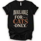 A black short-sleeve t-shirt with a distressed graphic that reads 'AVAILABLE FOR CATS ONLY.' in beige and brown-orange lettering, featuring a black cat illustration.