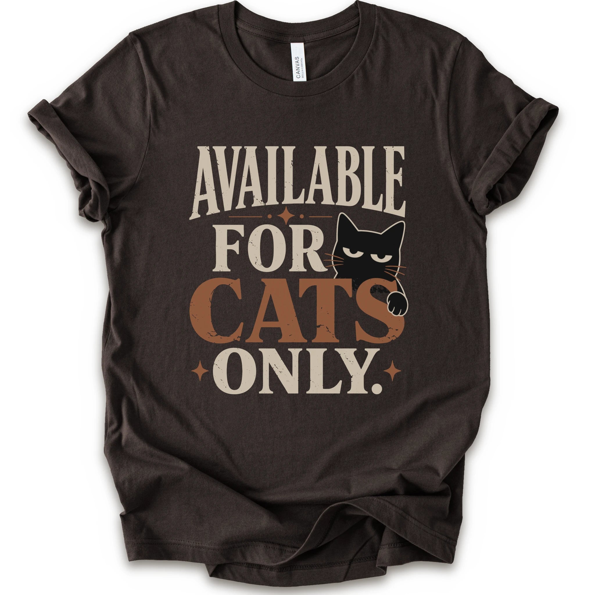 A brown short-sleeve t-shirt with a distressed graphic that reads 'AVAILABLE FOR CATS ONLY.' in beige and brown-orange lettering, featuring a black cat illustration.