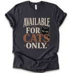 A dark grey short-sleeve t-shirt with a distressed graphic that reads 'AVAILABLE FOR CATS ONLY.' in beige and brown-orange lettering, featuring a black cat illustration.