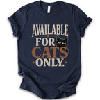 A navy short-sleeve t-shirt with a distressed graphic that reads 'AVAILABLE FOR CATS ONLY.' in beige and brown-orange lettering, featuring a black cat illustration.