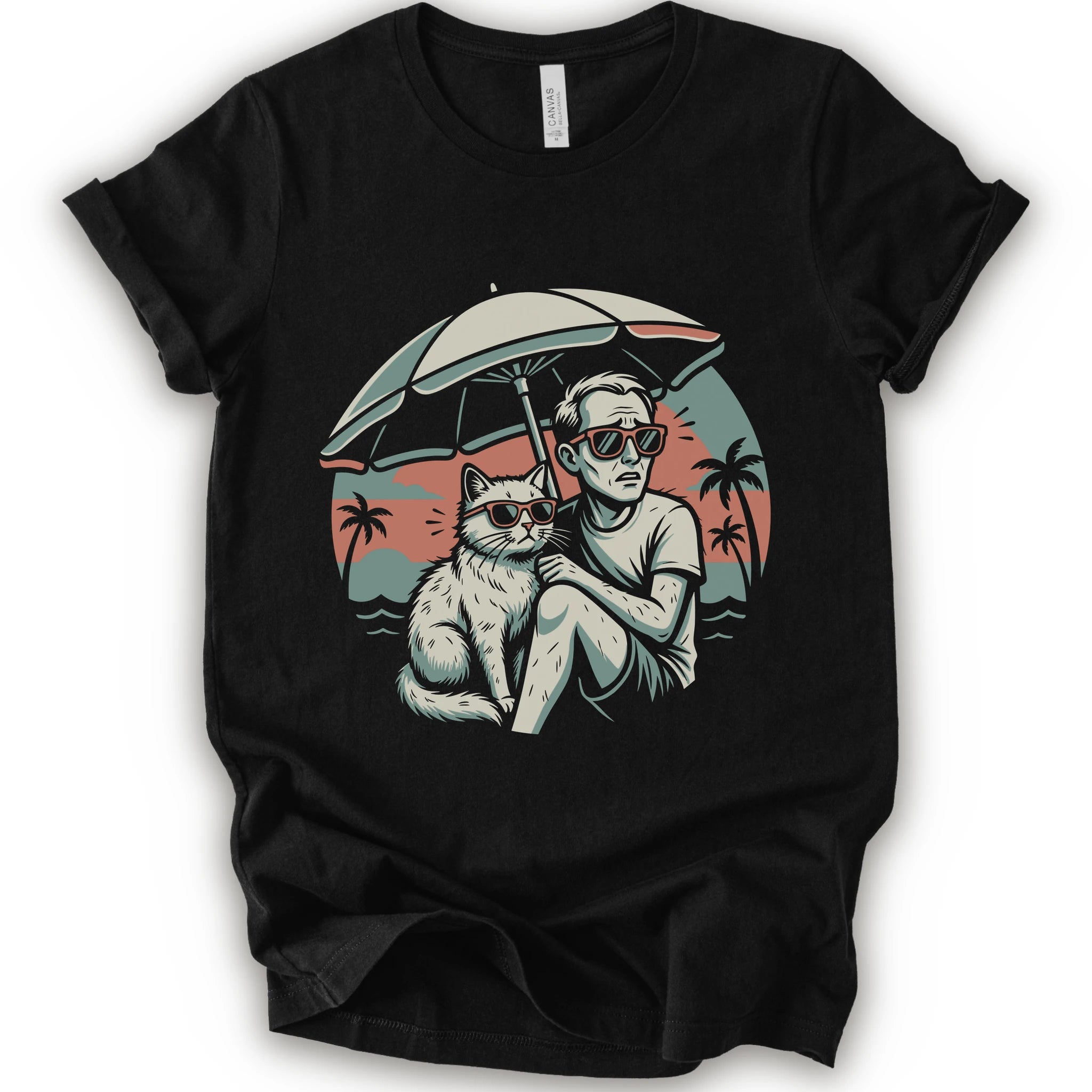 A black short-sleeve crewneck t-shirt with a vintage-style graphic print of a man and a cat sitting under a beach umbrella on a sunset beach.