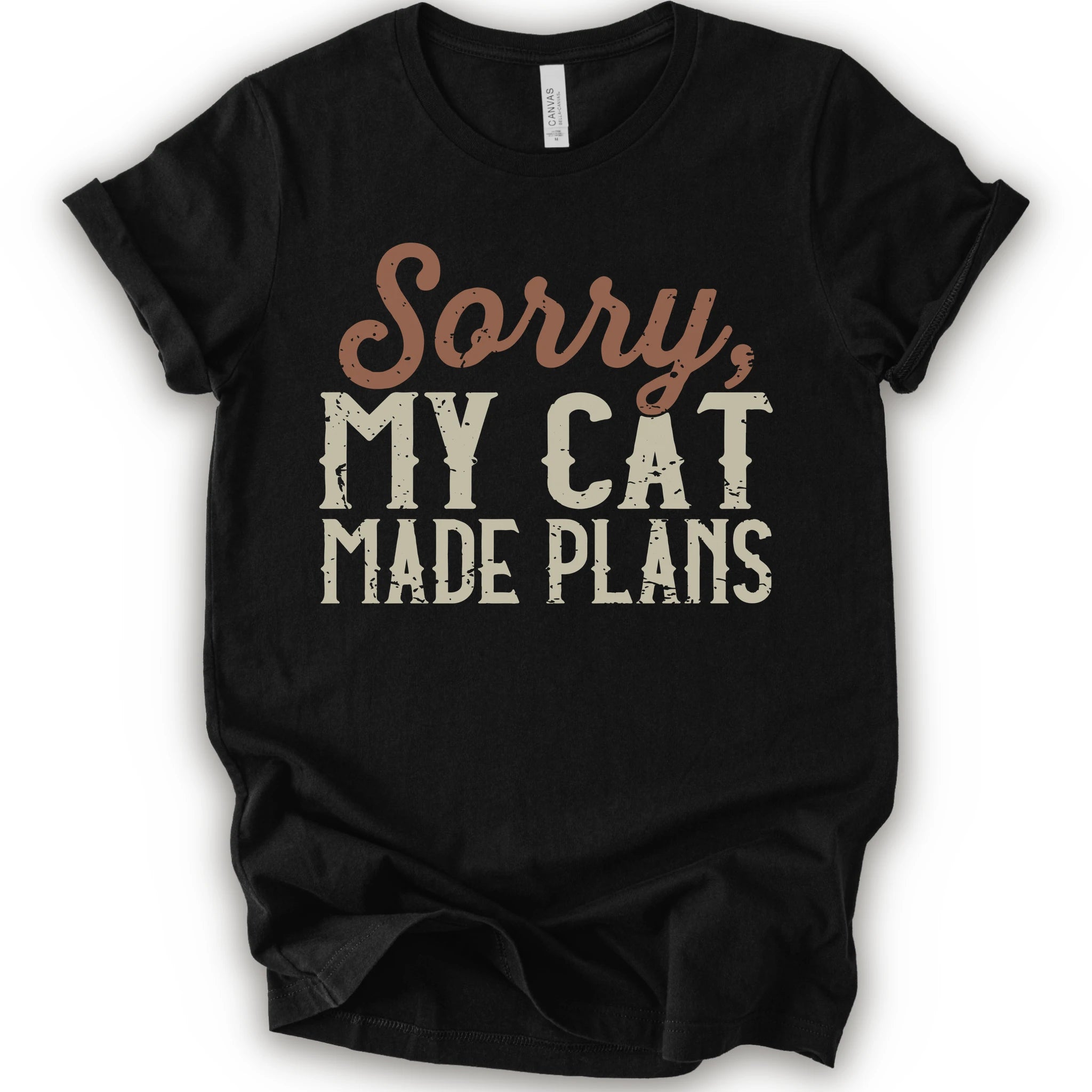 A black short-sleeve crewneck t-shirt with a distressed graphic print that reads 'Sorry, MY CAT MADE PLANS' in brown and off-white lettering