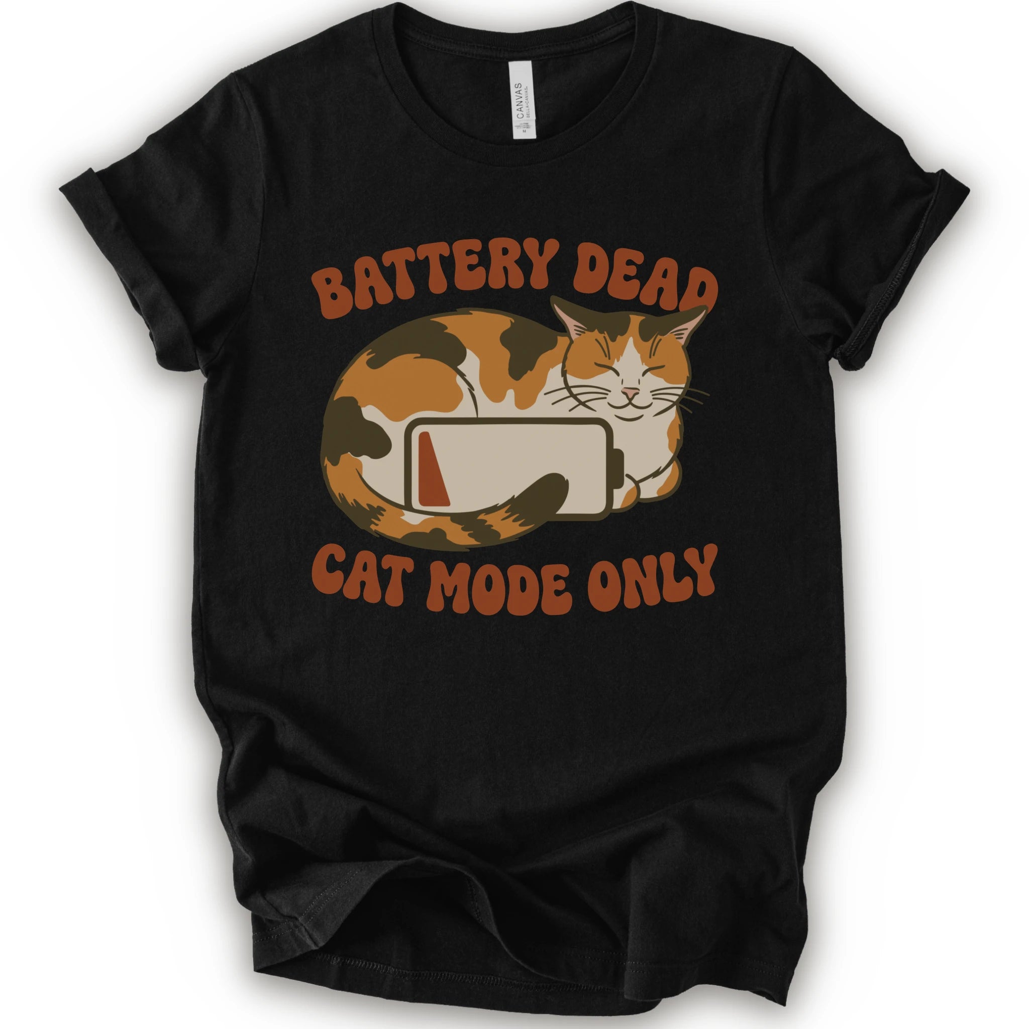 A black short-sleeve graphic t-shirt featuring a cartoon calico cat curled up around a battery icon, with the text 'BATTERY DEAD CAT MODE ONLY' in orange-brown lettering.