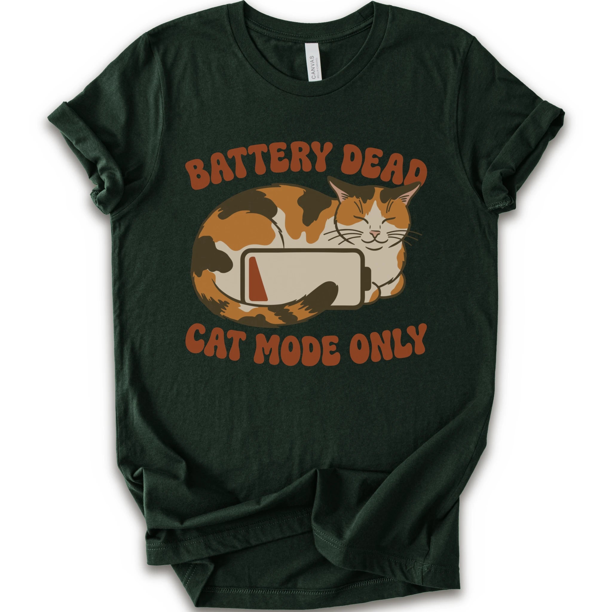 A forest short-sleeve graphic t-shirt featuring a cartoon calico cat curled up around a battery icon, with the text 'BATTERY DEAD CAT MODE ONLY' in orange-brown lettering.