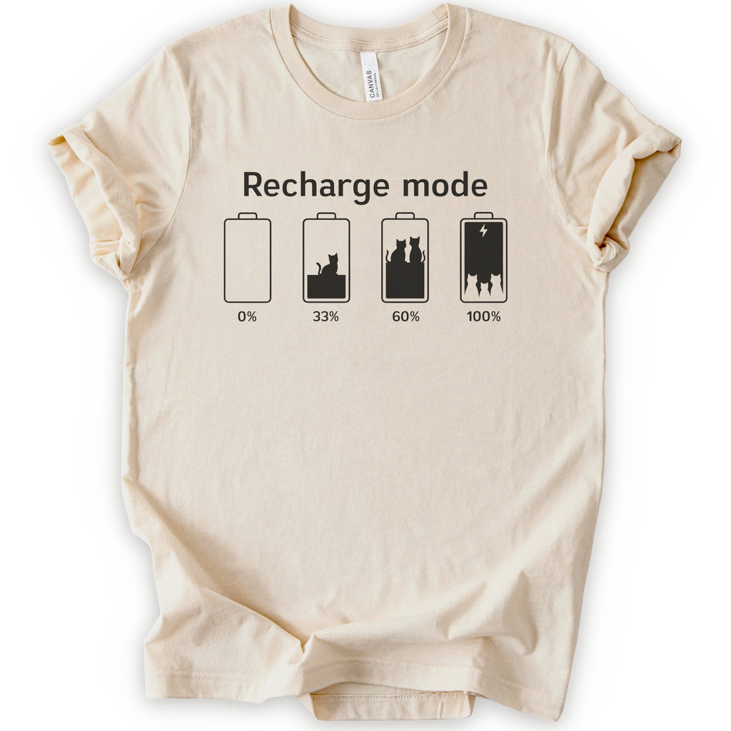 A natural short-sleeve crewneck t-shirt with a graphic print on the front. The graphic features the text 'Recharge mode' above four battery icons showing battery levels from 0% to 100% with a cat silhouette inside the batteries.