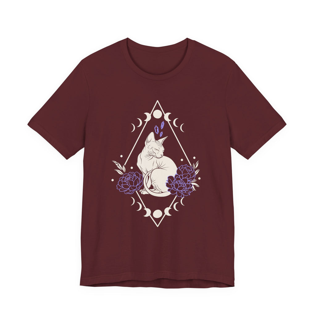 A maroon short-sleeve crewneck t-shirt featuring a graphic with white Sphynx cat with moon phases, crystals, peonies and geometric diamond line art