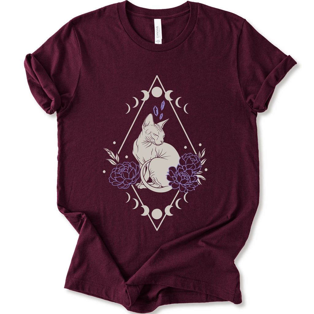 Maroon graphic t-shirt with white Sphynx cat with lavender flowers, crystals, moon phases and a geometric celestial frame