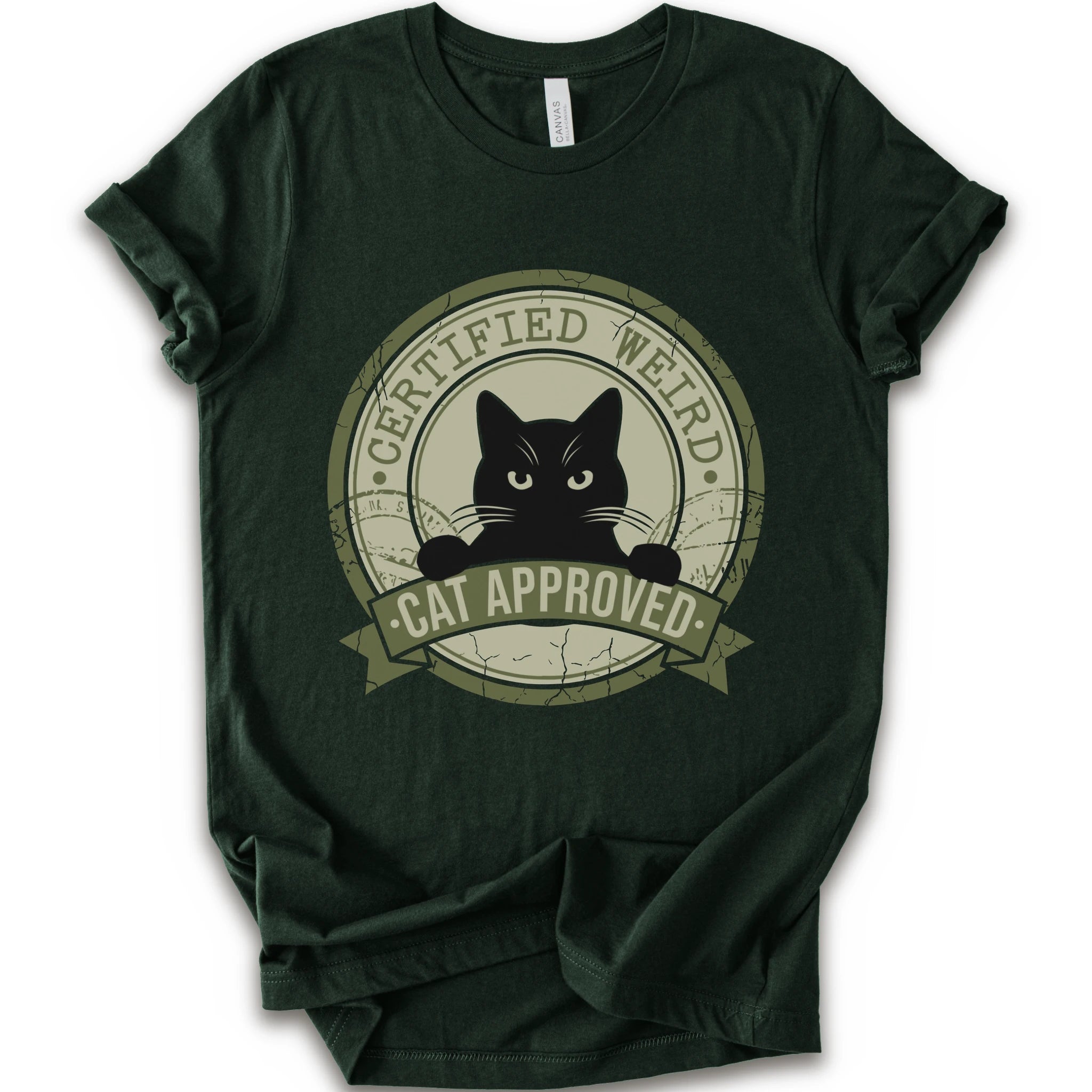 A forest short-sleeve crewneck t-shirt with a vintage-style circular graphic on the front. The graphic features a black cat peeking out from inside a distressed olive green circle with a banner reading 'CERTIFIED WEIRD - CAT APPROVED'.