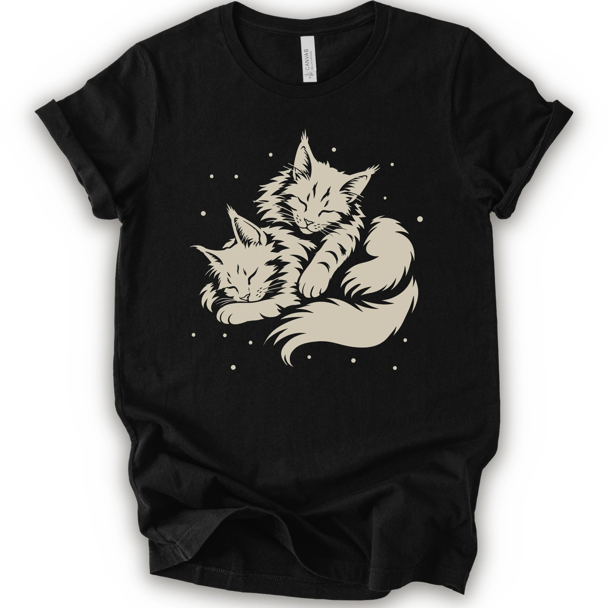 A black short-sleeve crewneck t-shirt featuring a cream-colored graphic of two sleeping fluffy kittens nestled together on a white background.  