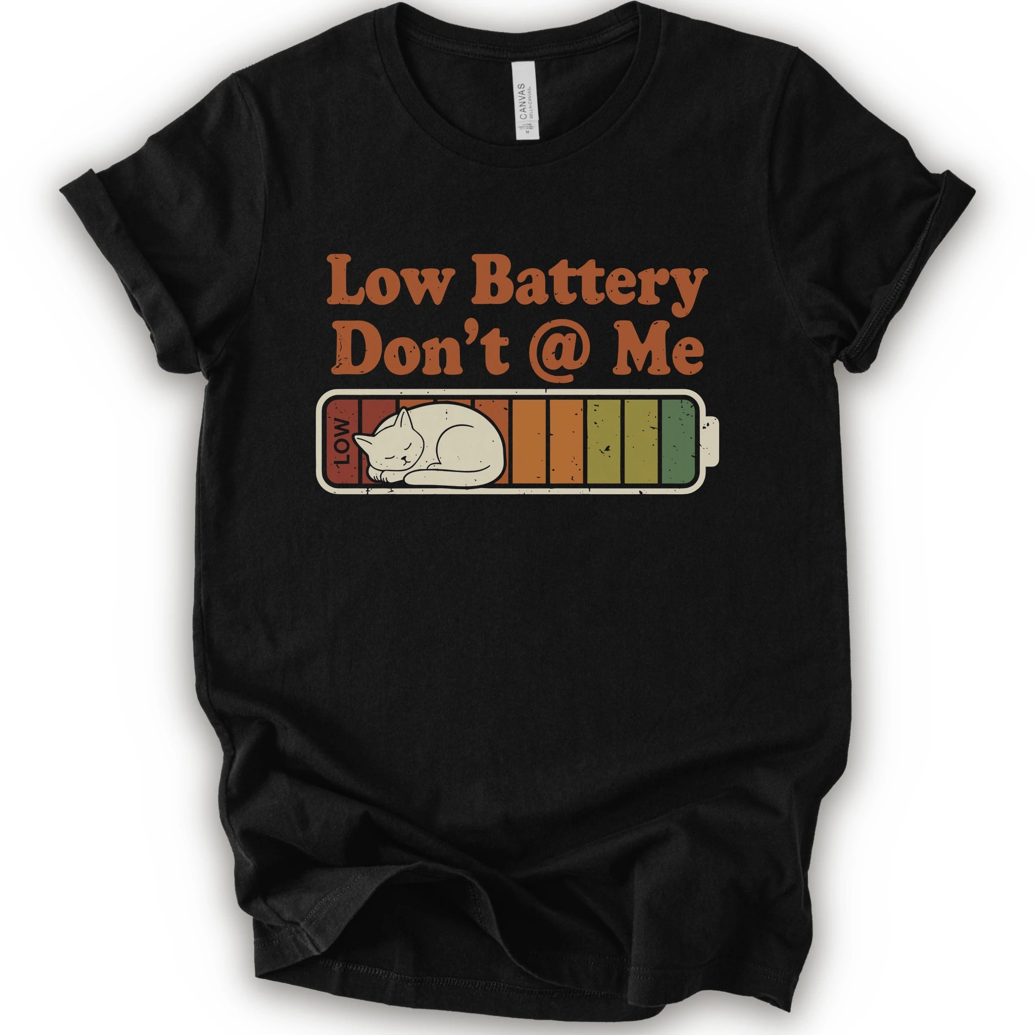 A black short-sleeve t-shirt with a graphic print that reads 'Low Battery Don't @ Me' above a retro battery icon containing a sleeping cat.