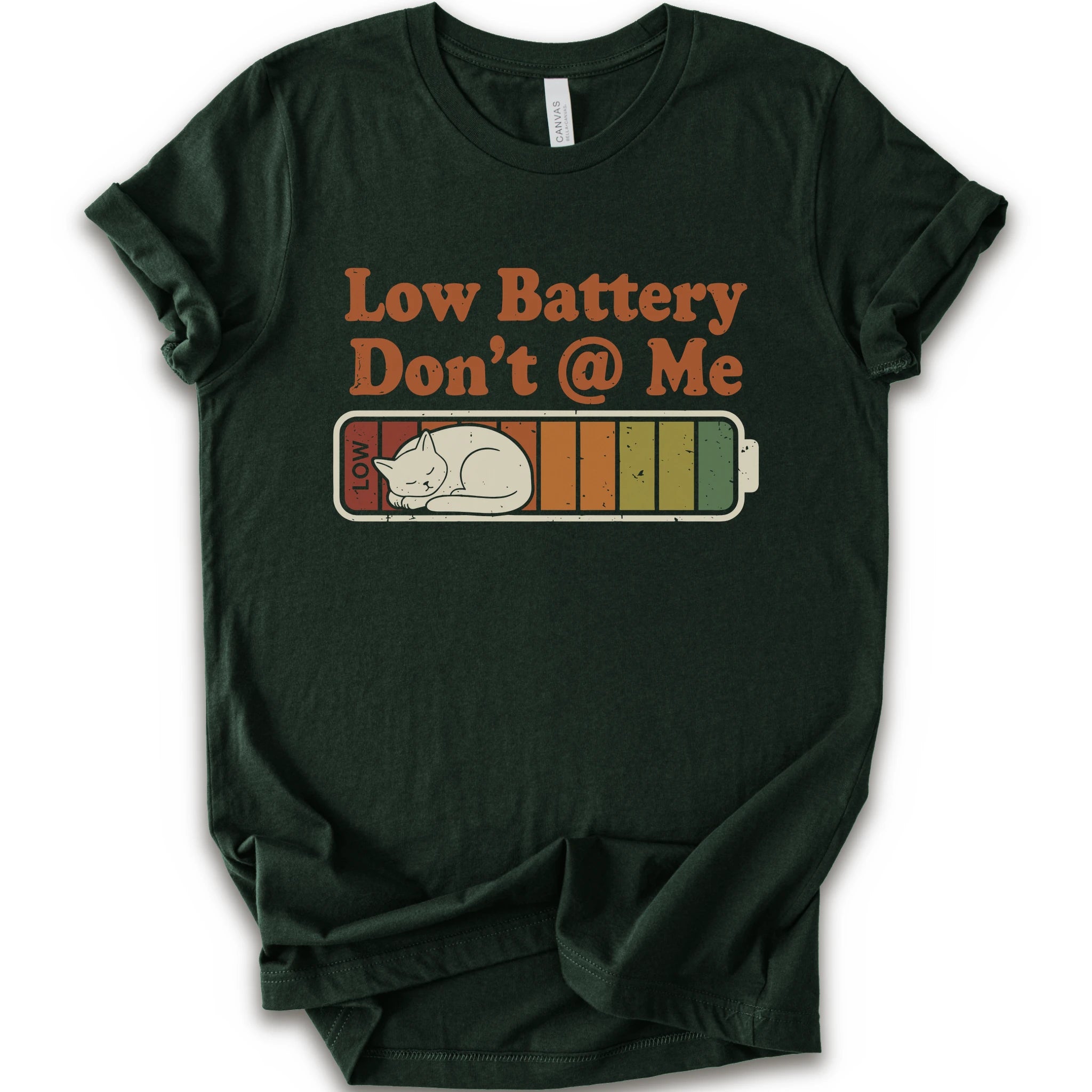 A forest short-sleeve t-shirt with a graphic print that reads 'Low Battery Don't @ Me' above a retro battery icon containing a sleeping cat.