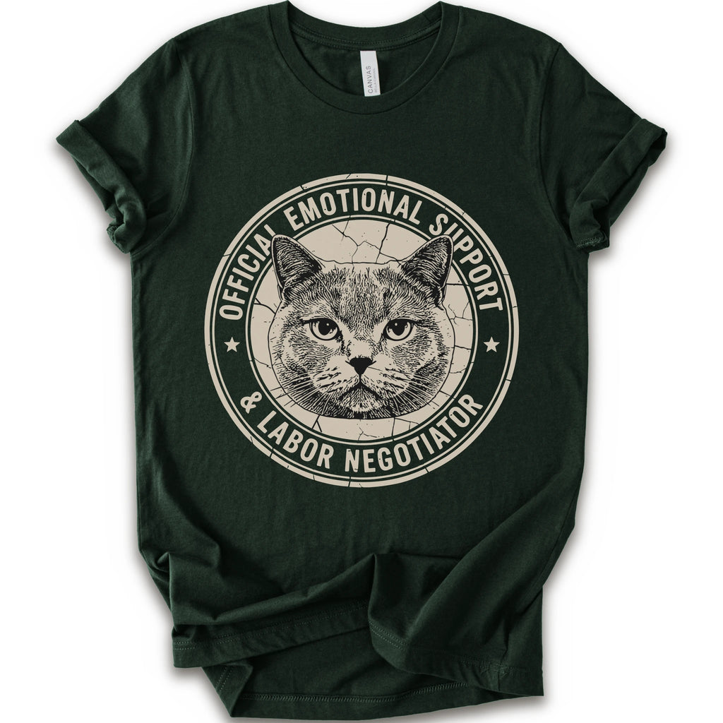 A forest short-sleeve crewneck t-shirt with a distressed circular graphic on the chest featuring a cat's face and the text 'OFFICIAL EMOTIONAL SUPPORT & LABOR NEGOTIATOR'.