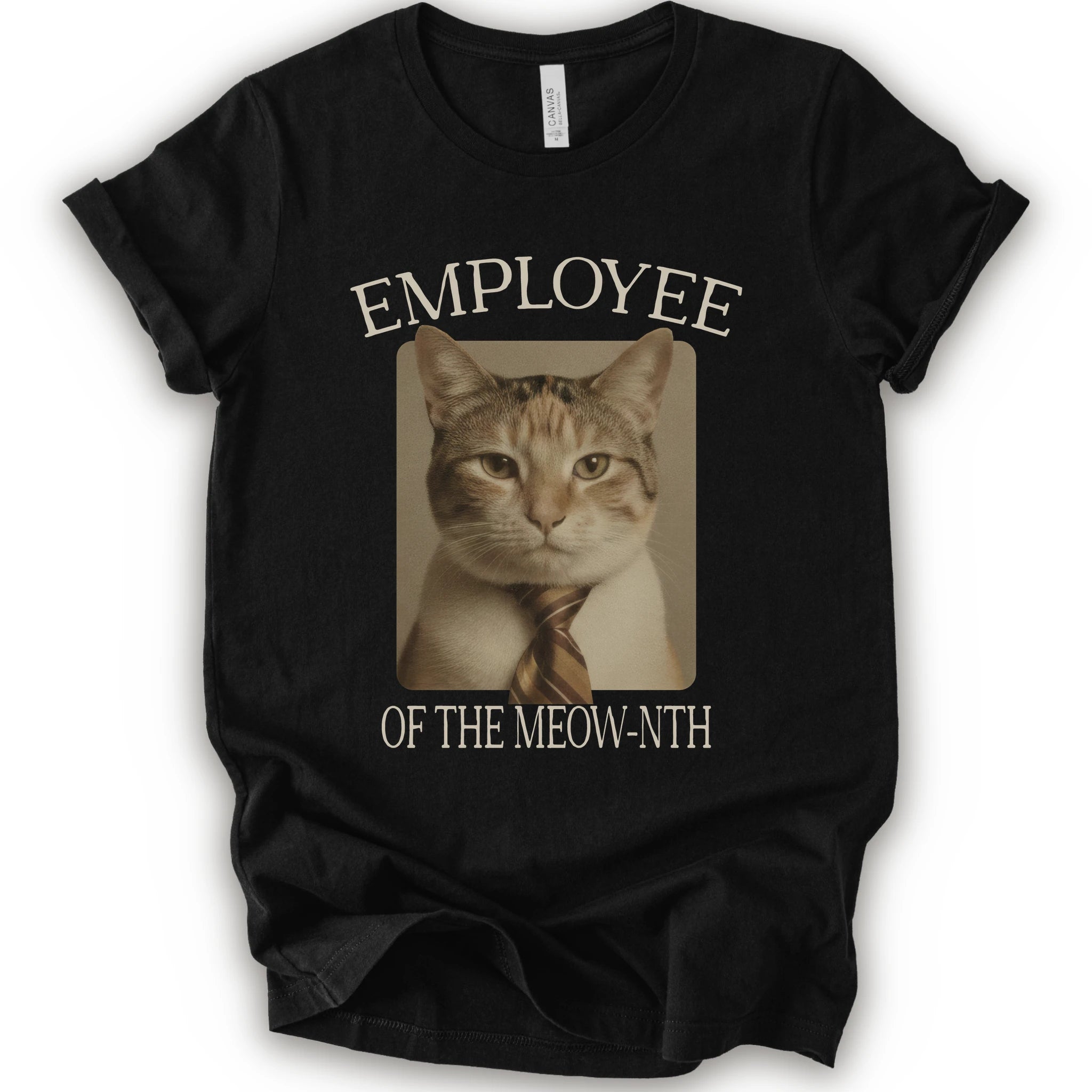 A black short-sleeve crewneck t-shirt with a graphic print of a cat wearing a tie inside a beige frame, with the text 'EMPLOYEE OF THE MEOW-NTH' in beige lettering.