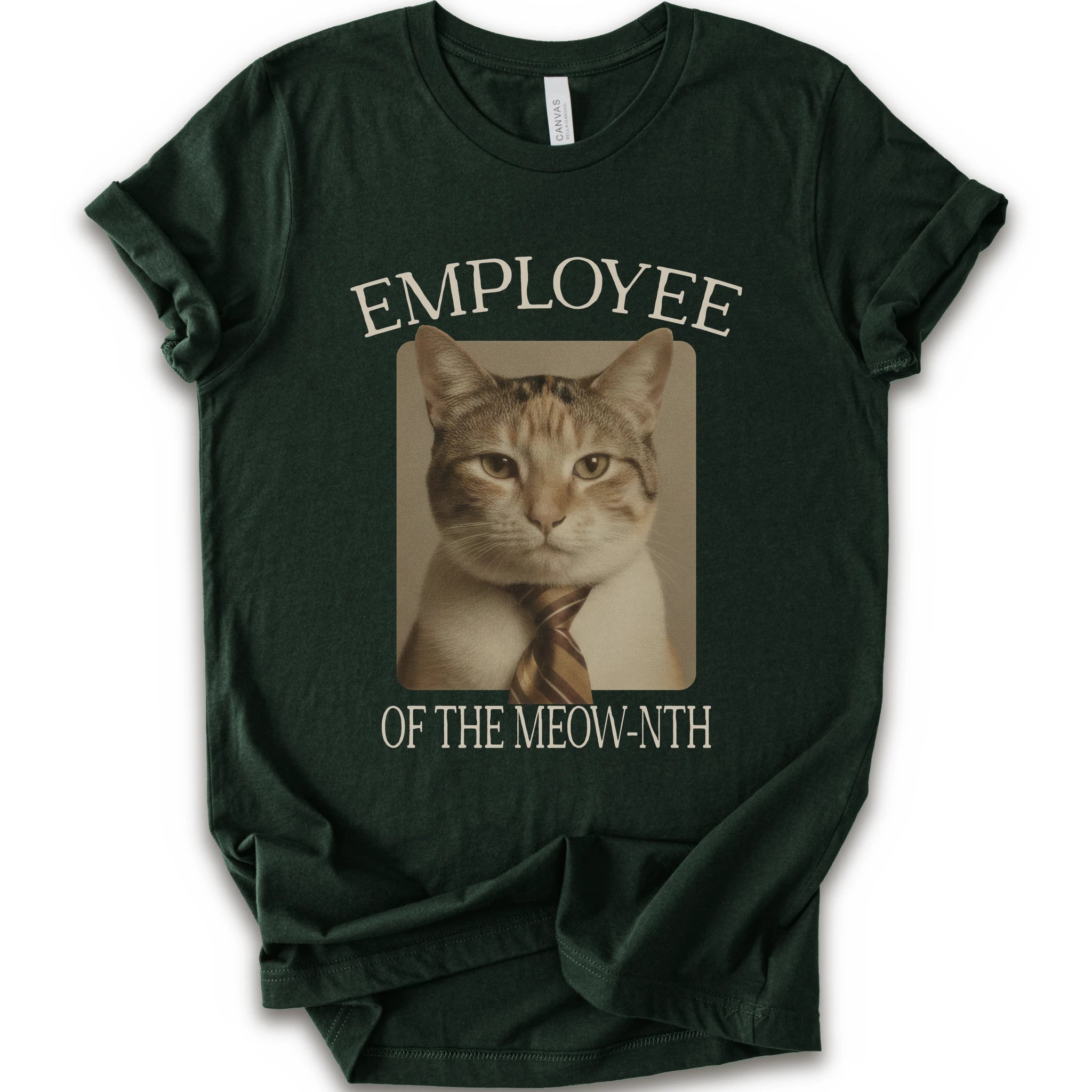 A forest short-sleeve crewneck t-shirt with a graphic print of a cat wearing a tie inside a beige frame, with the text 'EMPLOYEE OF THE MEOW-NTH' in beige lettering.