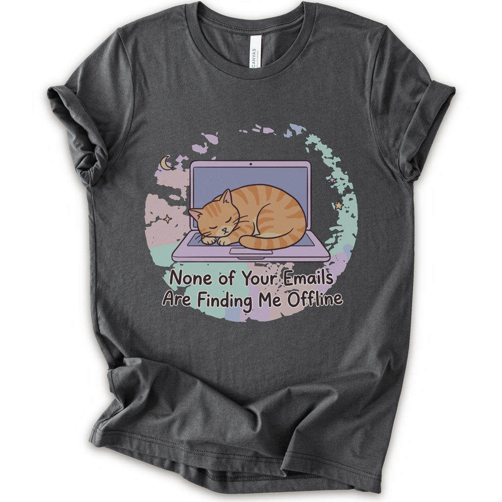 A asphalt short-sleeve graphic t-shirt featuring an illustration of an orange tabby cat sleeping on a laptop with the text 'None of Your Emails Are Finding Me Offline' underneath.