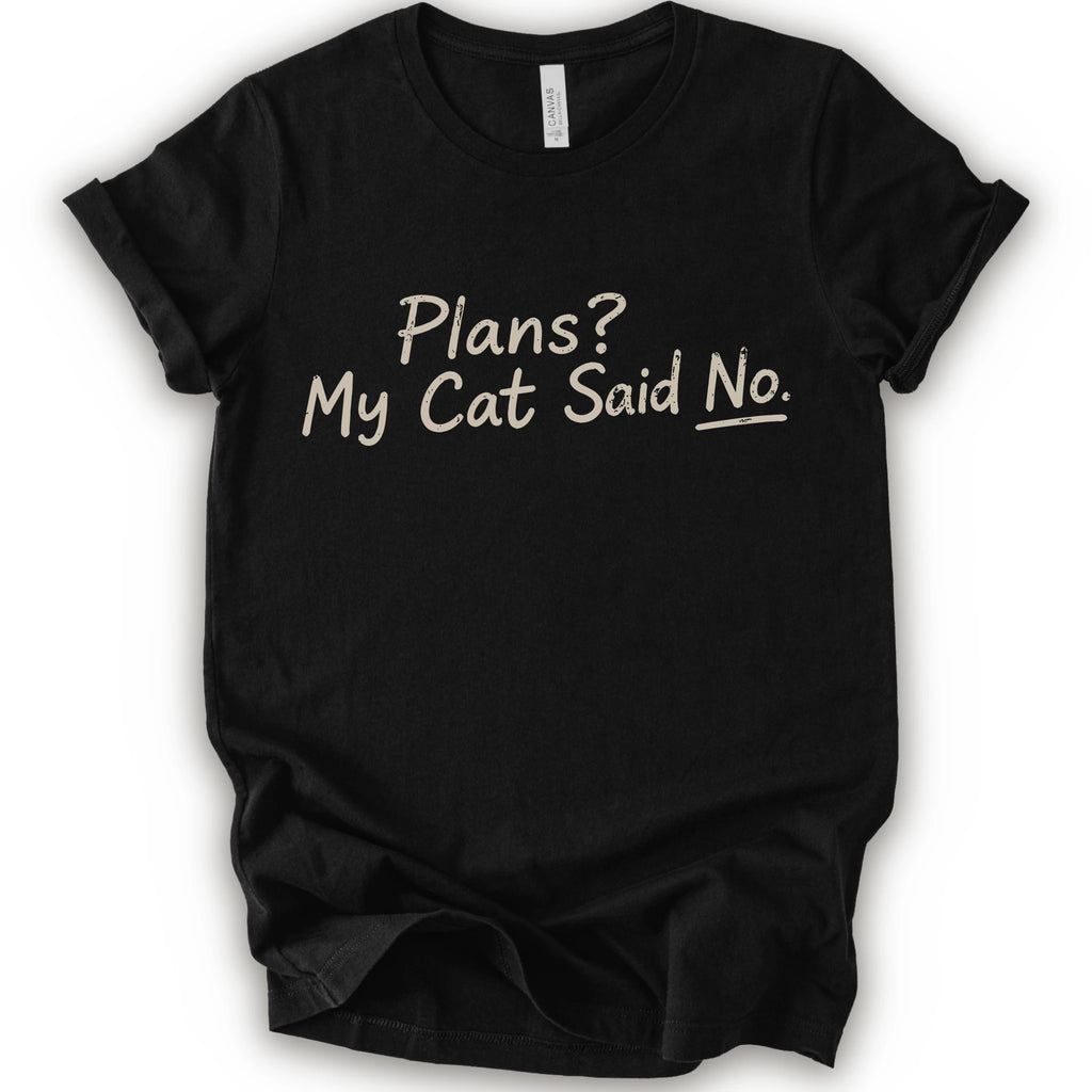 A black short-sleeve crewneck t-shirt with the phrase 'Plans? My Cat Said No.' printed in a beige handwritten font across the chest.