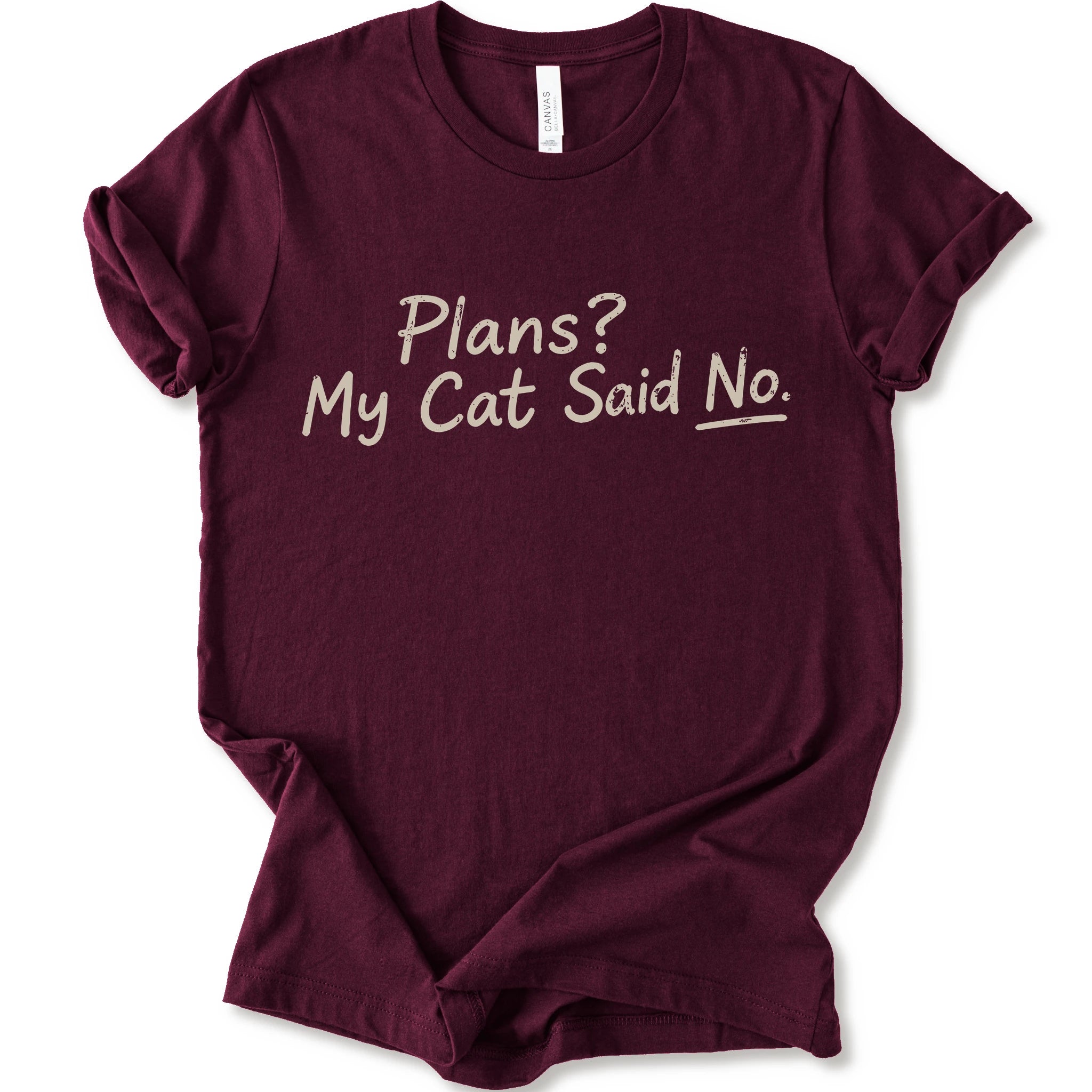 A maroon short-sleeve crewneck t-shirt with the phrase 'Plans? My Cat Said No.' printed in a beige handwritten font across the chest.