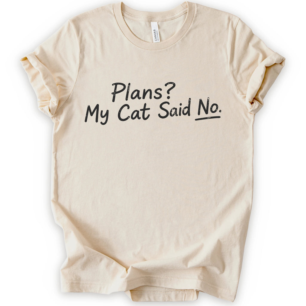 A natural short-sleeve crewneck t-shirt with the phrase 'Plans? My Cat Said No.' printed in a black handwritten font across the chest.