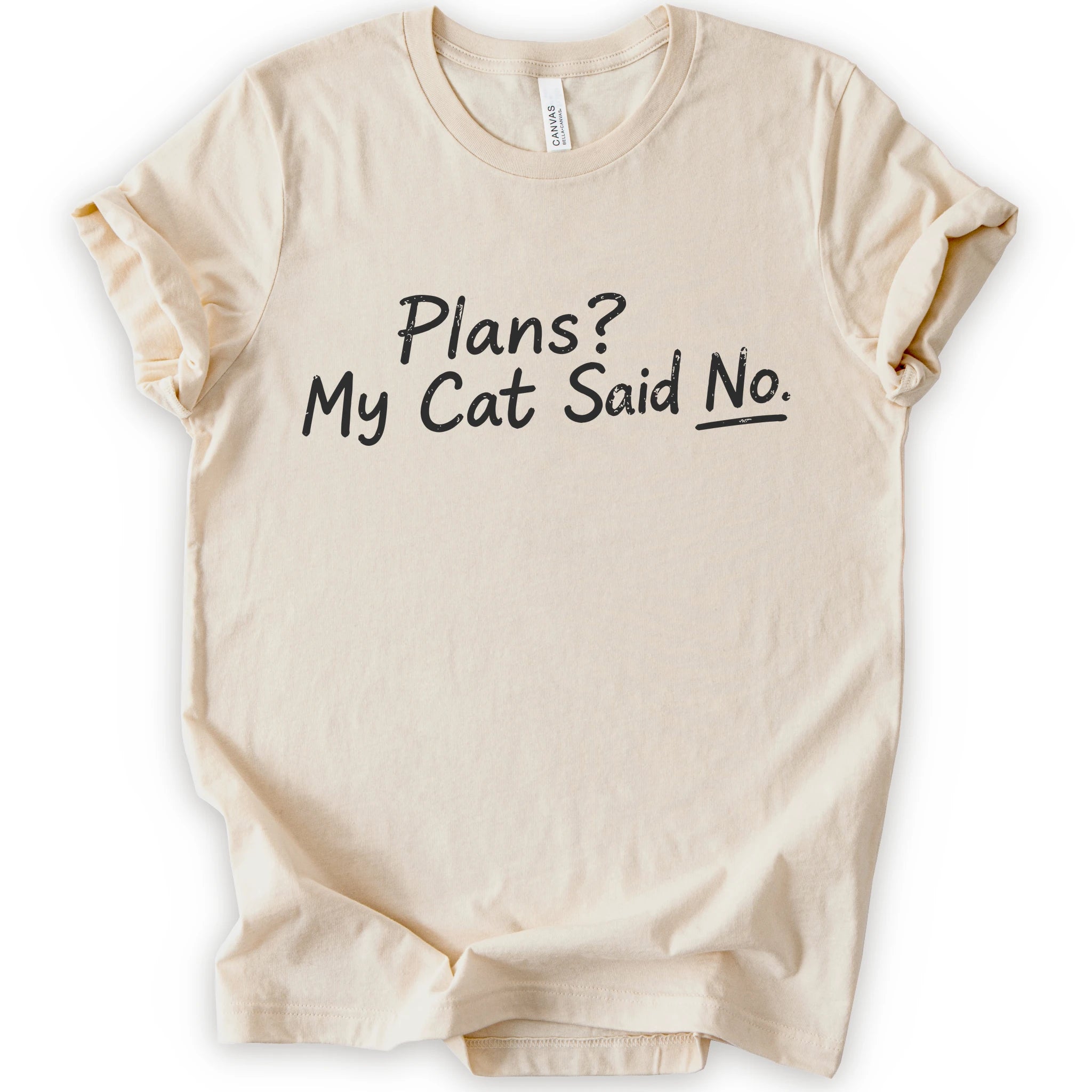 A natural short-sleeve crewneck t-shirt with the phrase 'Plans? My Cat Said No.' printed in a black handwritten font across the chest.