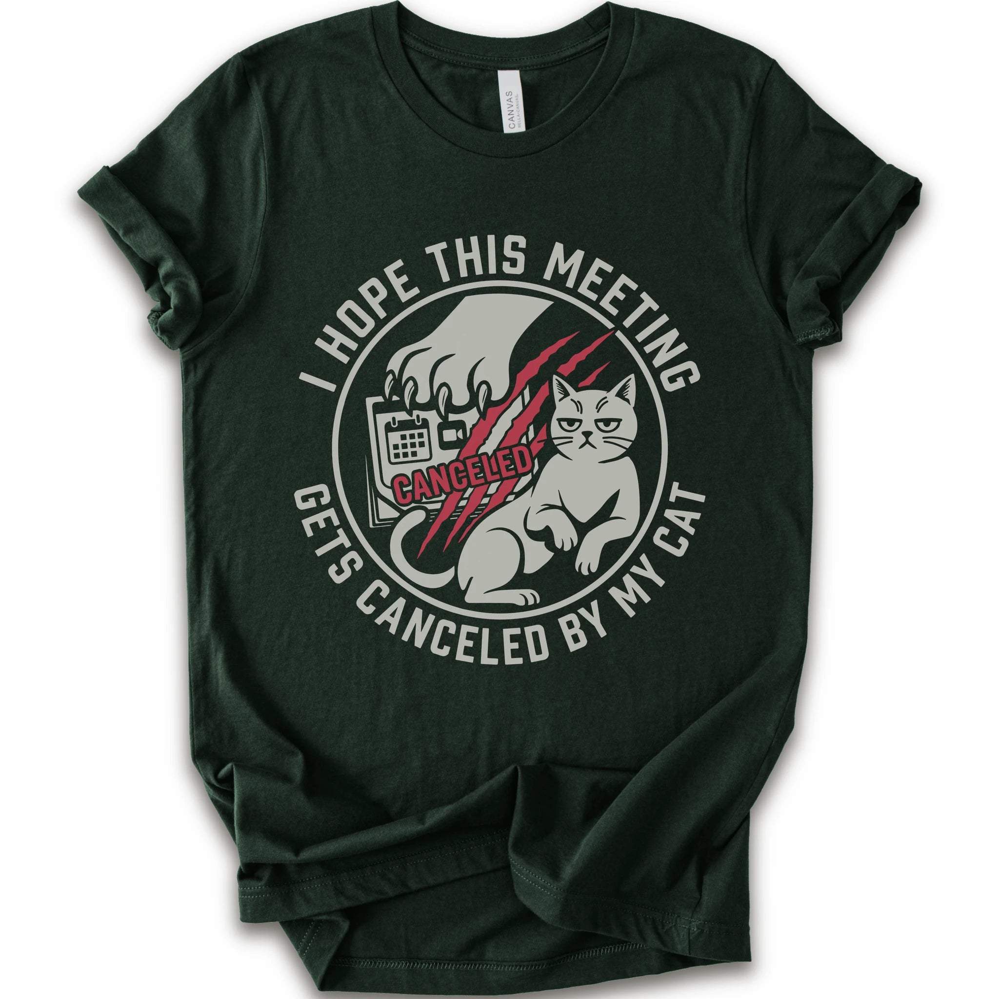 A forest short-sleeve crewneck t-shirt with a circular graphic on the front. The graphic features a white cat, a hand scratching, and the text 'I HOPE THIS MEETING GETS CANCELLED BY MY CAT' in white, with 'CANCELLED' written in red script.