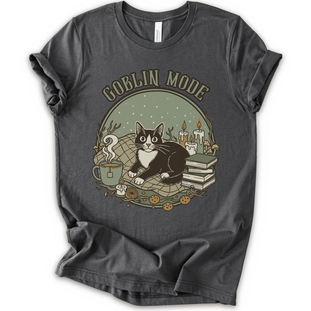 A asphalt short-sleeve crewneck t-shirt with a cozy 'Goblin Mode' graphic print featuring a black and white cat, candles, books, and a mug.