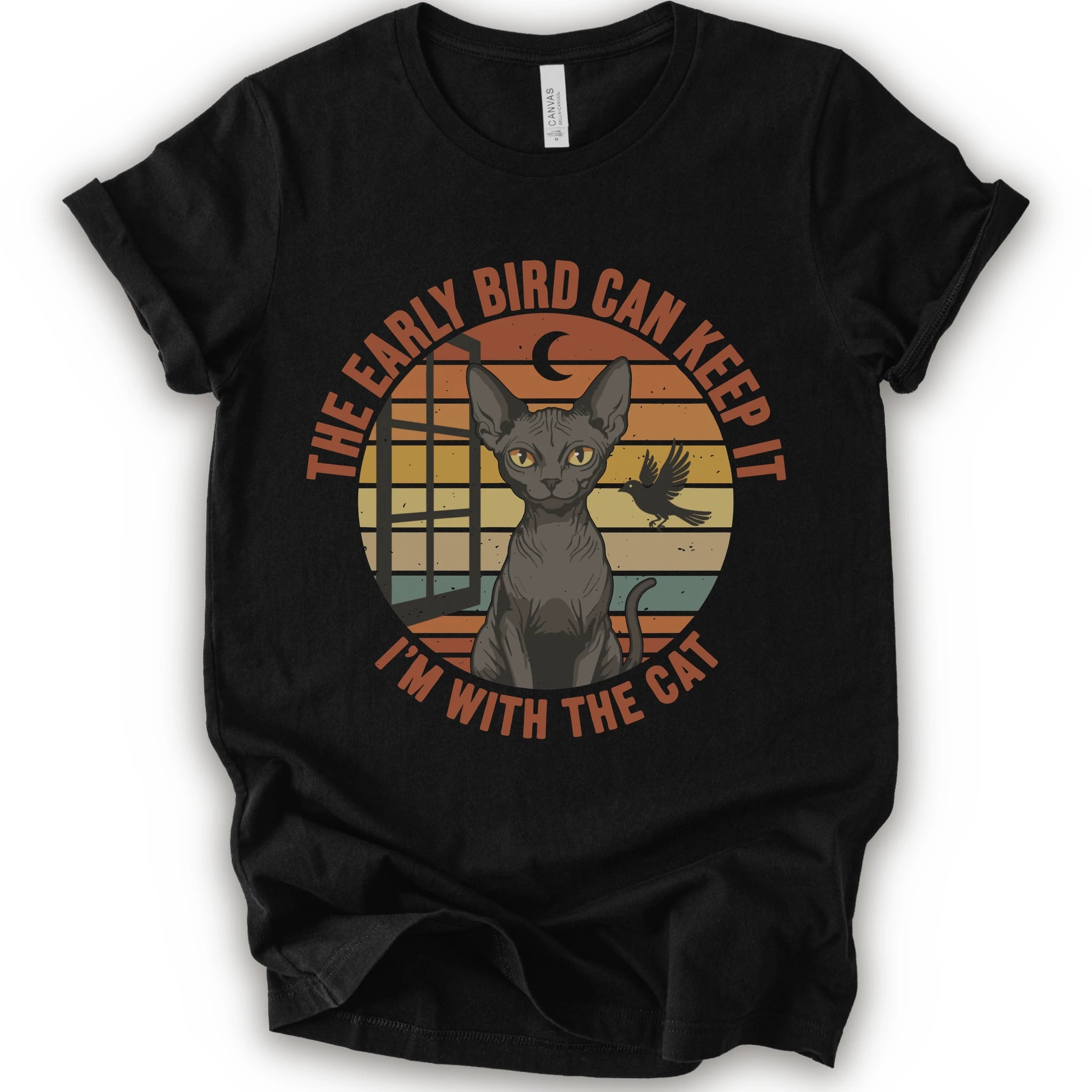 A black short-sleeve crewneck t-shirt with a graphic print of a hairless cat in front of a retro sunset circle, with the text 'THE EARLY BIRD CAN KEEP IT I'M WITH THE CAT'.