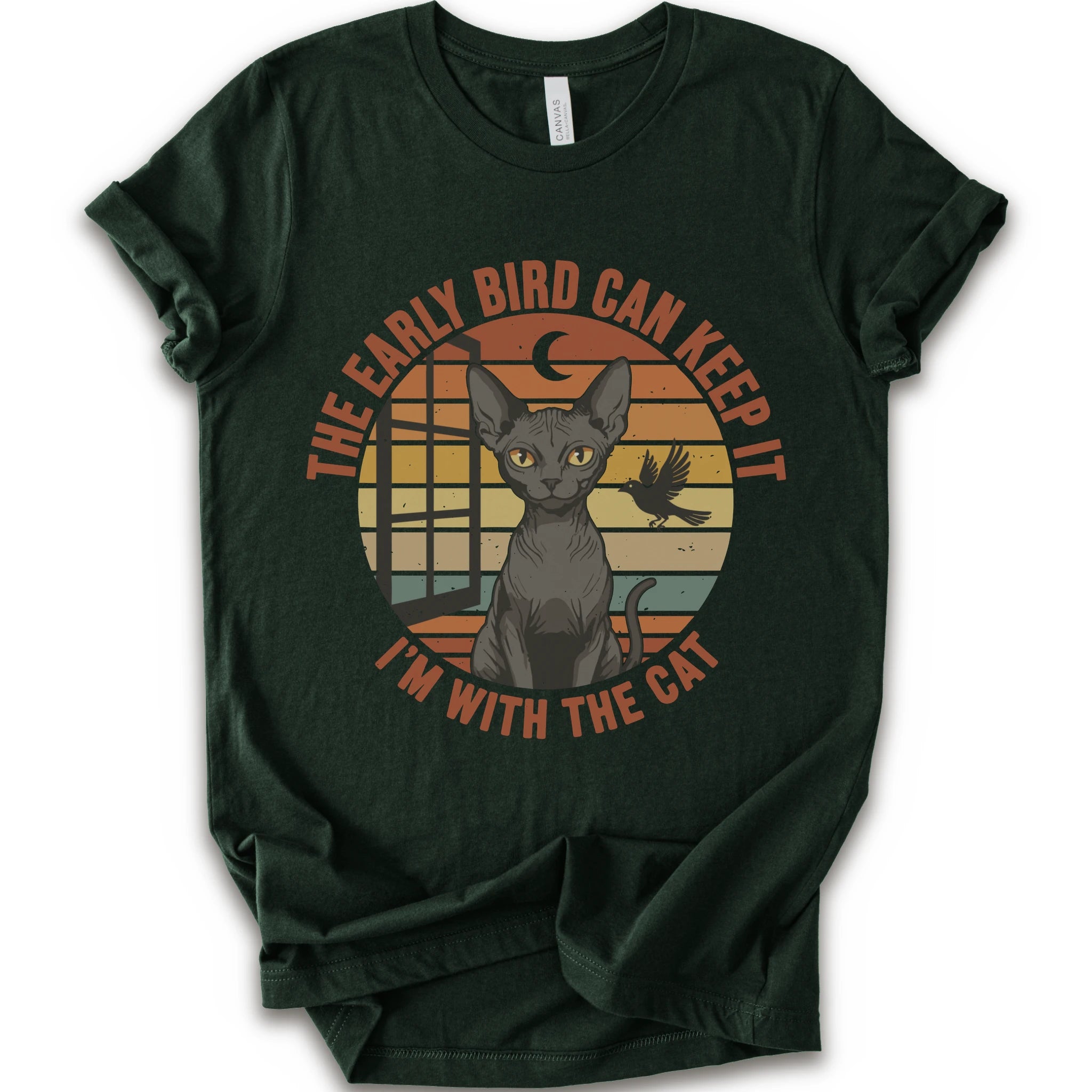 A forest short-sleeve crewneck t-shirt with a graphic print of a hairless cat in front of a retro sunset circle, with the text 'THE EARLY BIRD CAN KEEP IT I'M WITH THE CAT'.