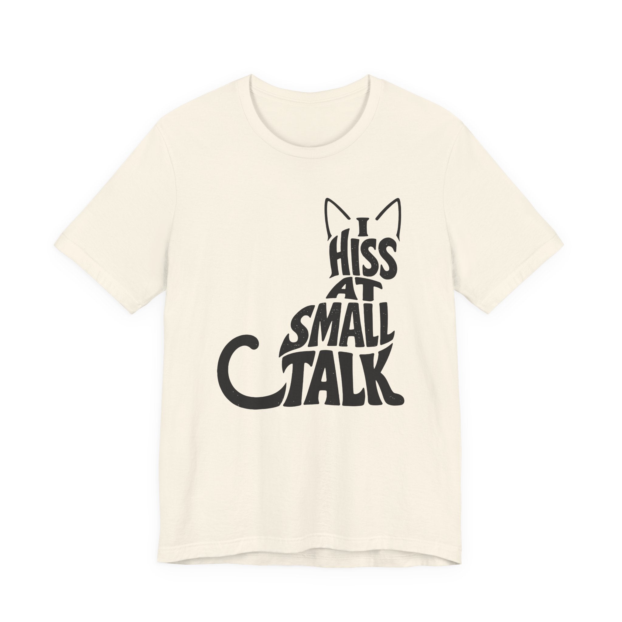 A natural short-sleeve crewneck t-shirt featuring a graphic with black “I Hiss at Small Talk” typography with pointed cat ears and a large curved tail