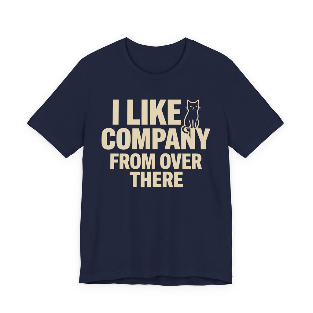 A navy short-sleeve t-shirt with a beige graphic print that reads "I Like Company From Over There" with an unimpressed sitting cat