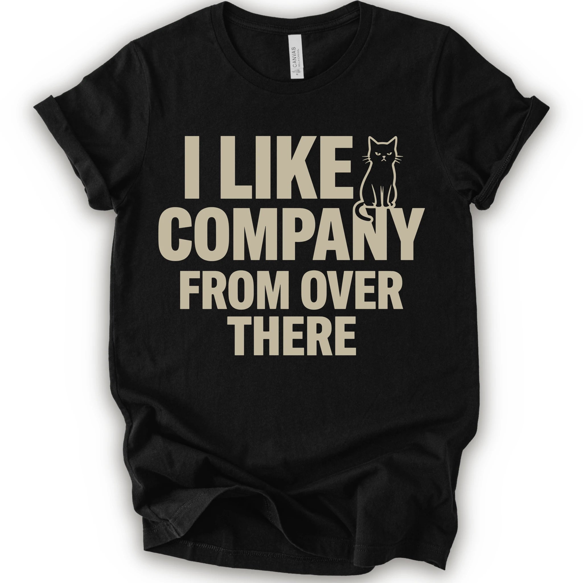 Black graphic t-shirt  with "I Like Company From Over There" text with an unimpressed sitting cat in a bold stacked T-shirt design