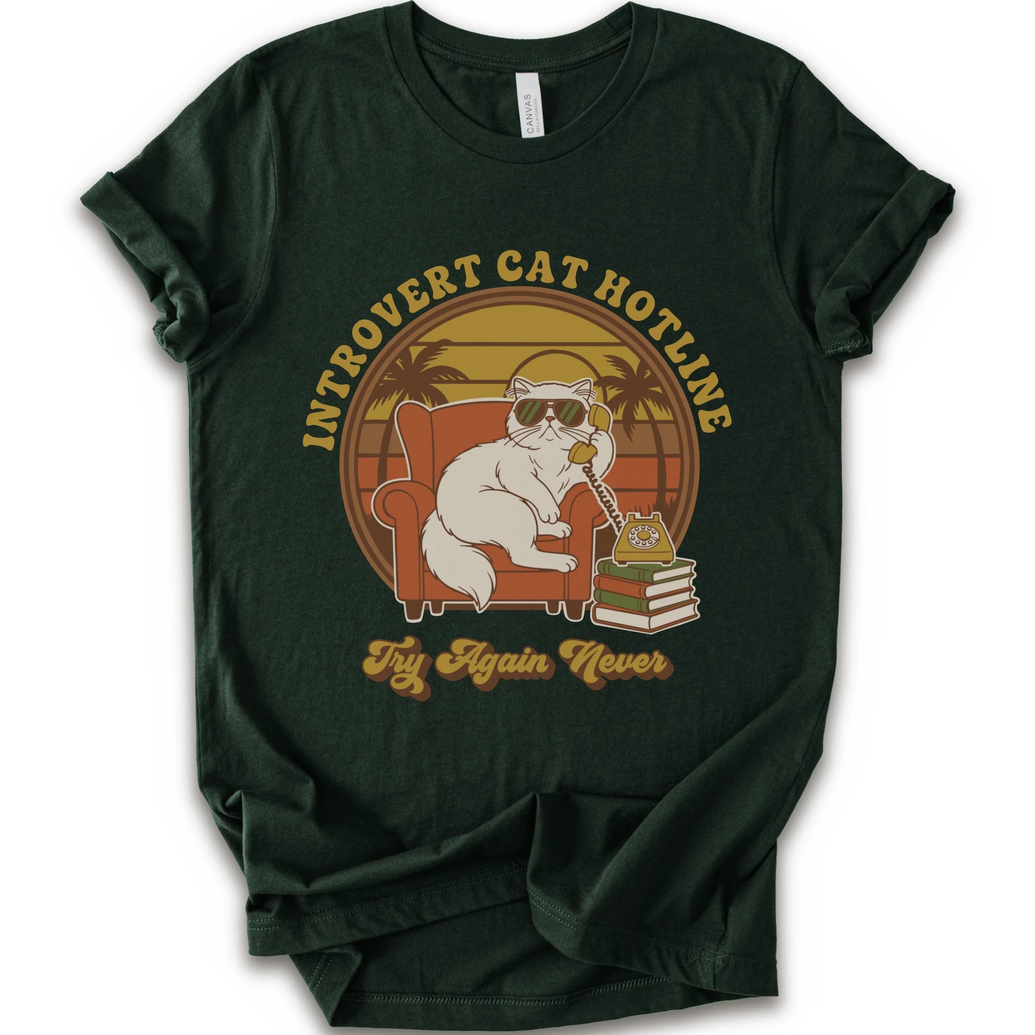 A forest short-sleeve crewneck t-shirt with a retro-style graphic of a white cat wearing sunglasses and sitting in an orange armchair, surrounded by the text 'INTROVERT CAT HOTLINE' and 'Try Again Never'.