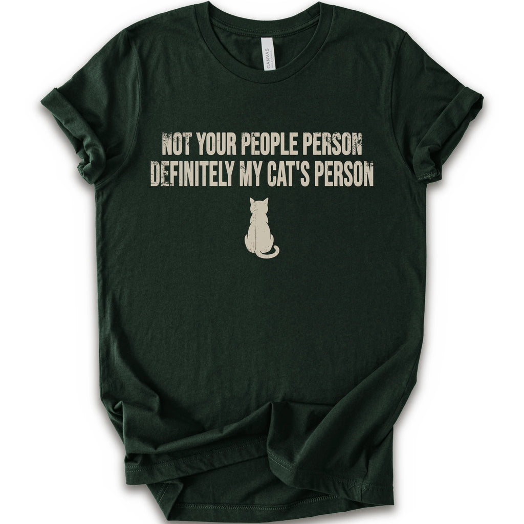 A forest short-sleeve crewneck t-shirt with a beige graphic print that reads 'NOT YOUR PEOPLE PERSON DEFINITELY MY CAT'S PERSON' above a small cat silhouette.