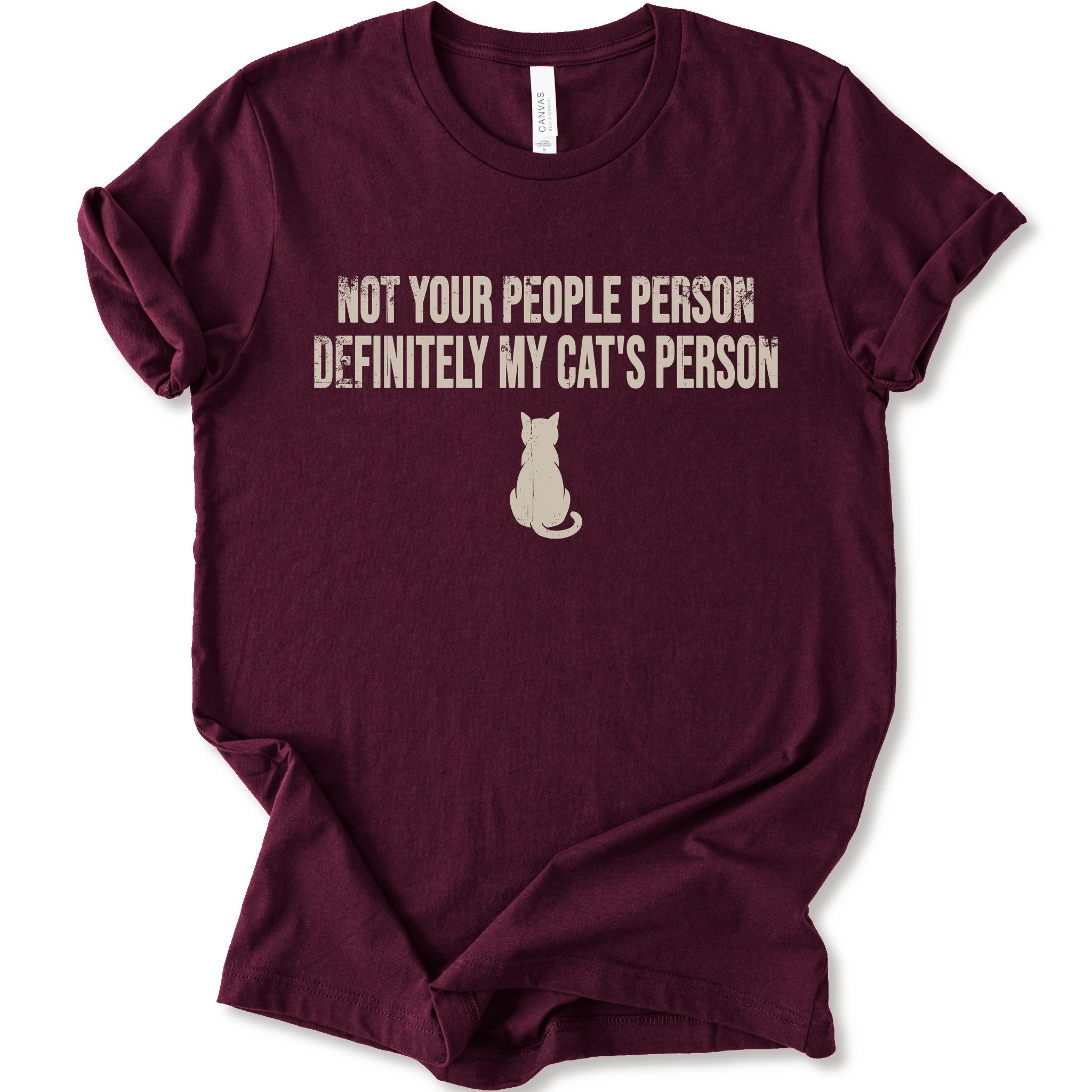 A maroon short-sleeve crewneck t-shirt with a beige graphic print that reads 'NOT YOUR PEOPLE PERSON DEFINITELY MY CAT'S PERSON' above a small cat silhouette.