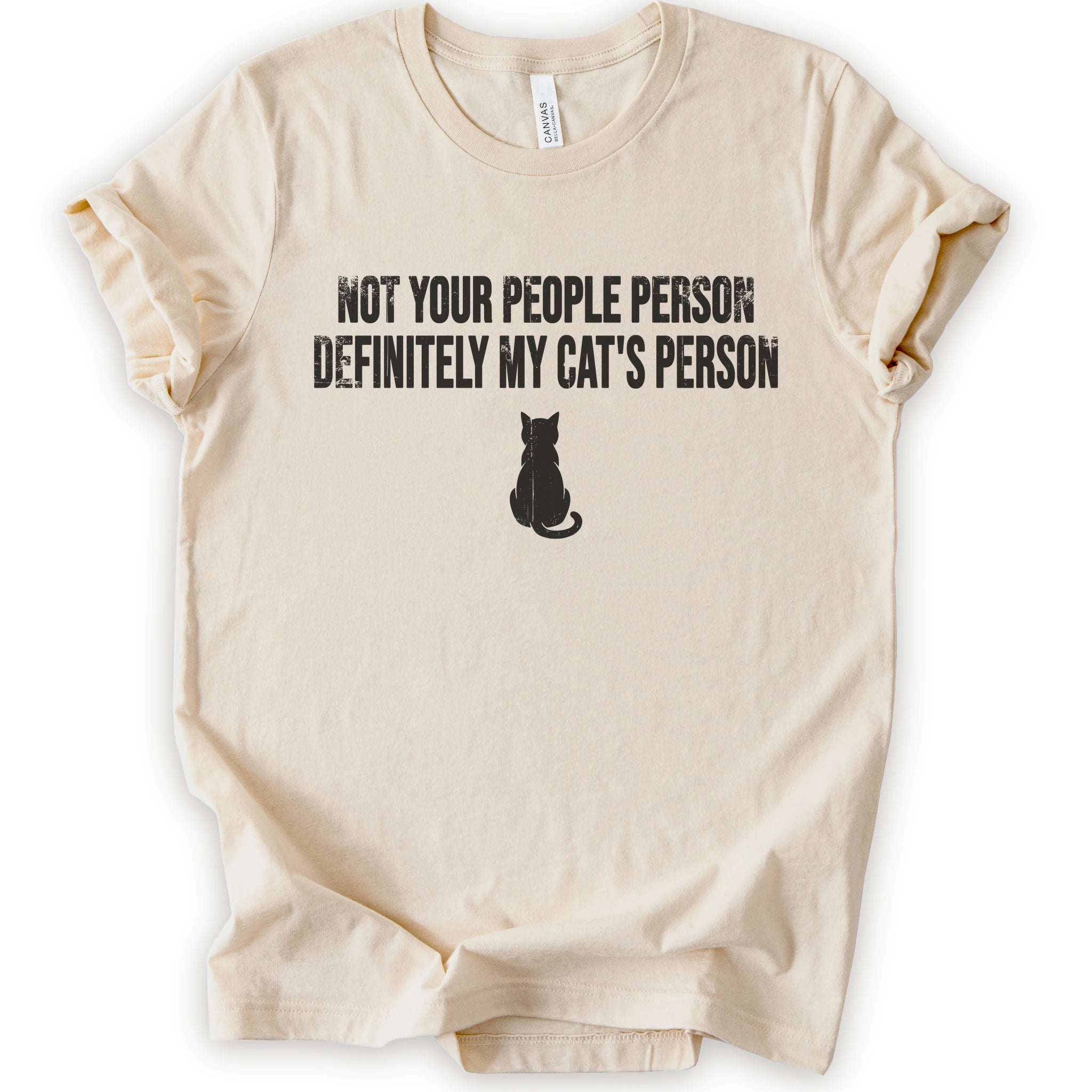 A natural short-sleeve crewneck t-shirt with a black graphic print that reads 'NOT YOUR PEOPLE PERSON DEFINITELY MY CAT'S PERSON' above a small cat silhouette.