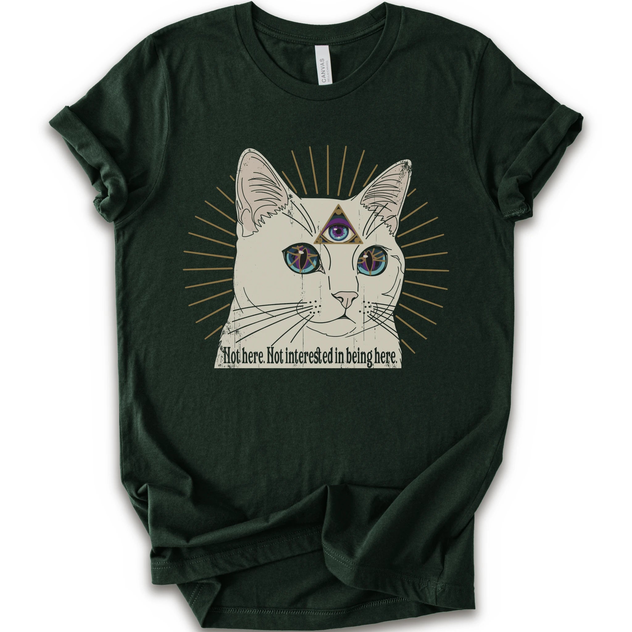 A forest short-sleeve crewneck t-shirt featuring a graphic of a white cat with a third eye and gold sunburst rays, with the text 'Not here. Not interested in being here.
