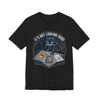 Black Tee with “It’s Not Looking Good” text above a cat reading tarot-style corporate cards with moons and stars