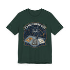 Green Tee with “It’s Not Looking Good” text above a cat reading tarot-style corporate cards with moons and stars