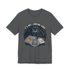 Grey Tee with “It’s Not Looking Good” text above a cat reading tarot-style corporate cards with moons and stars