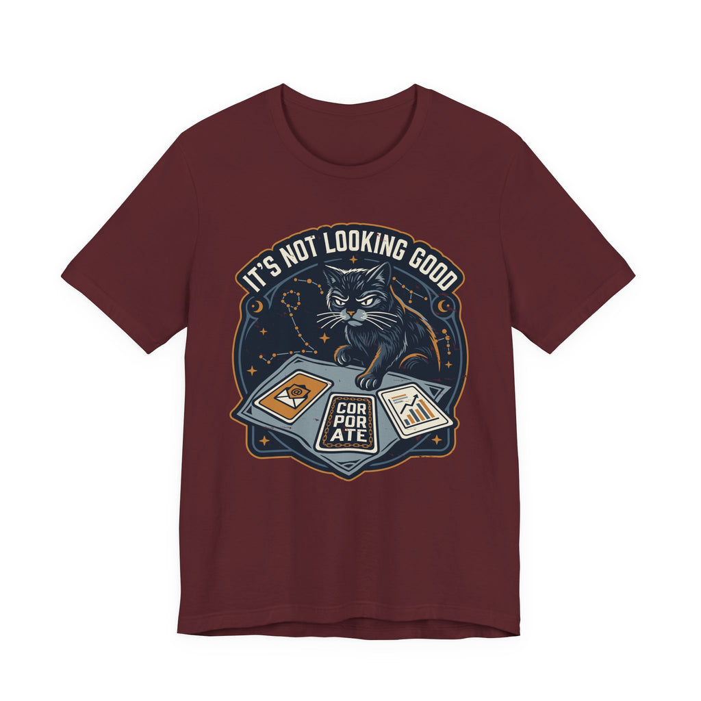 Red Tee with “It’s Not Looking Good” text above a cat reading tarot-style corporate cards with moons and stars