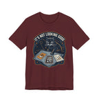 Red Tee with “It’s Not Looking Good” text above a cat reading tarot-style corporate cards with moons and stars