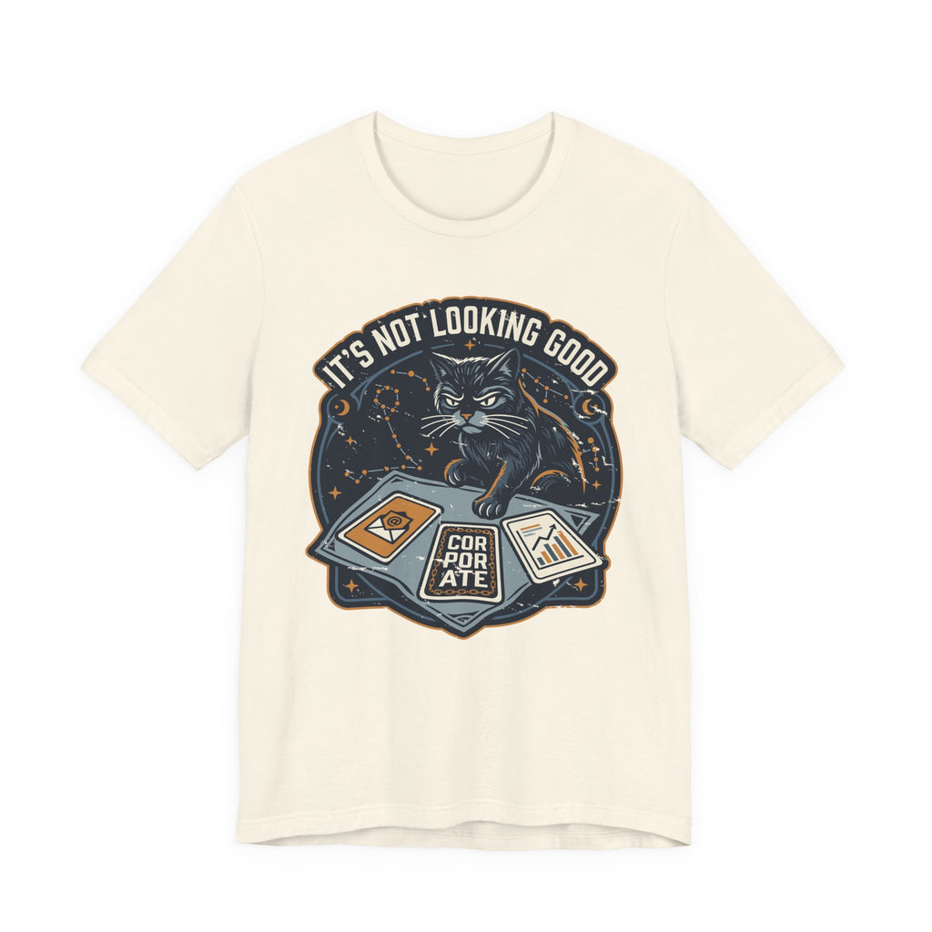 Cream Tee with “It’s Not Looking Good” text above a cat reading tarot-style corporate cards with moons and stars