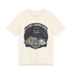 Cream Tee with “It’s Not Looking Good” text above a cat reading tarot-style corporate cards with moons and stars