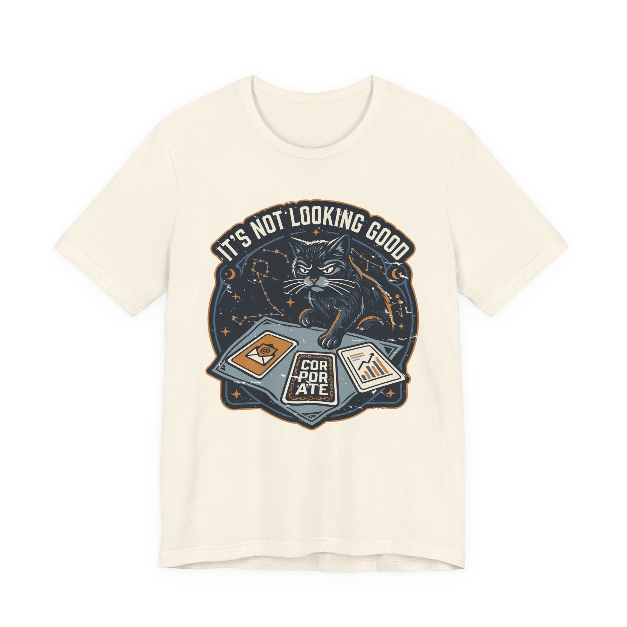 Cream Tee with “It’s Not Looking Good” text above a cat reading tarot-style corporate cards with moons and stars