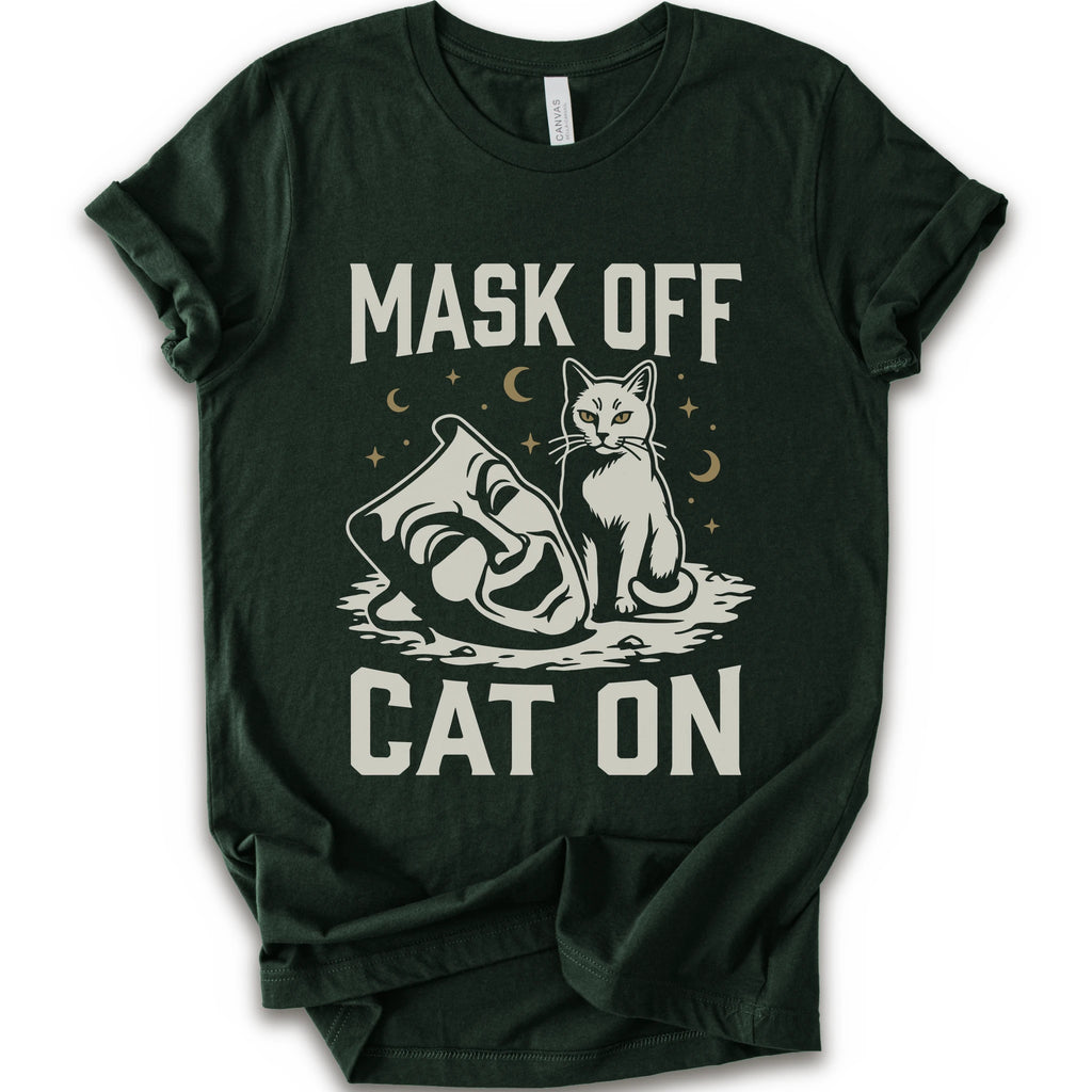 A forest short-sleeve crewneck t-shirt with a white graphic with gold moons and stars of a cat with a mask surrounded by the text 'MASK OFF' and 'CAT ON'.